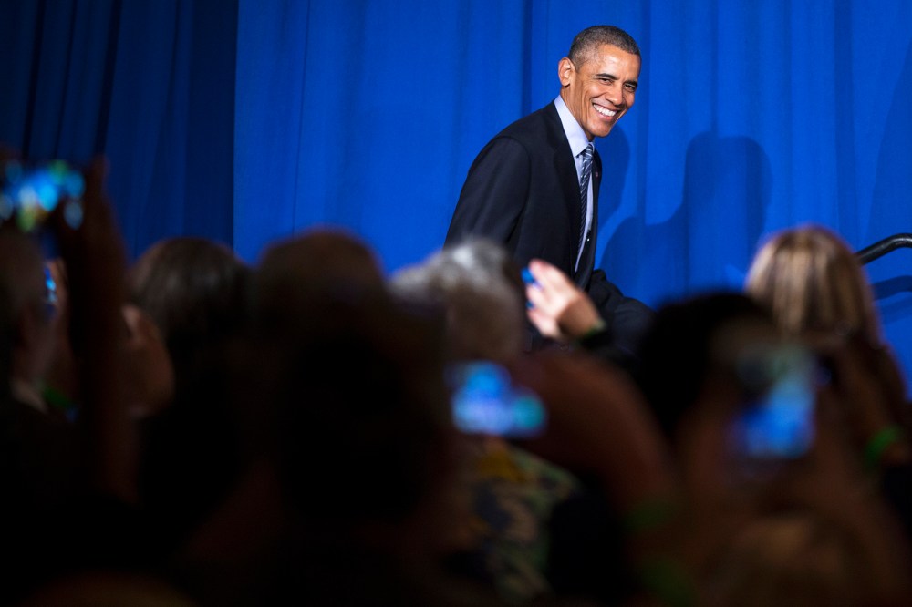 President Barack Obama smiles as he arrives to speak during a Organizing for Action event, on Nov. 9, 2015, in Washington, D.C. (Photo by Evan Vucci/AP)