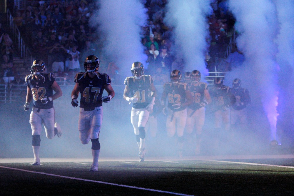 In this Aug. 16, 2014 file photo, members of the St. Louis Rams run onto the field before the start of an NFL football game in St. Louis, Mo. (Photo by Scott Kane/AP)