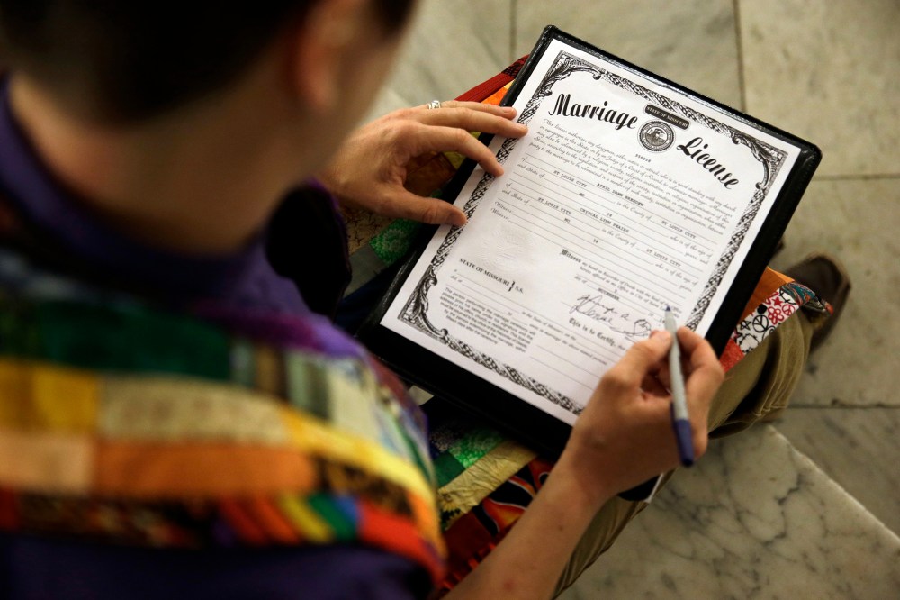 In this Nov. 5, 2014 file photo, a Missouri marriage license is signed after a same sex marriage ceremony in St. Louis, Mo. (Photo by Jeff Roberson/AP)