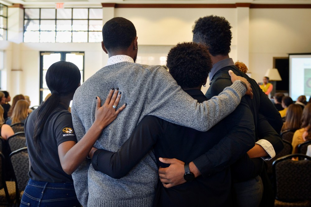 In this Saturday, Nov. 7, 2015, photo, members of an anti-racism and black awareness group embrace during a protest in the University of Missouri campus in Columbia, Mo. (Photo by Ellise Verheyen/Missourian/AP)