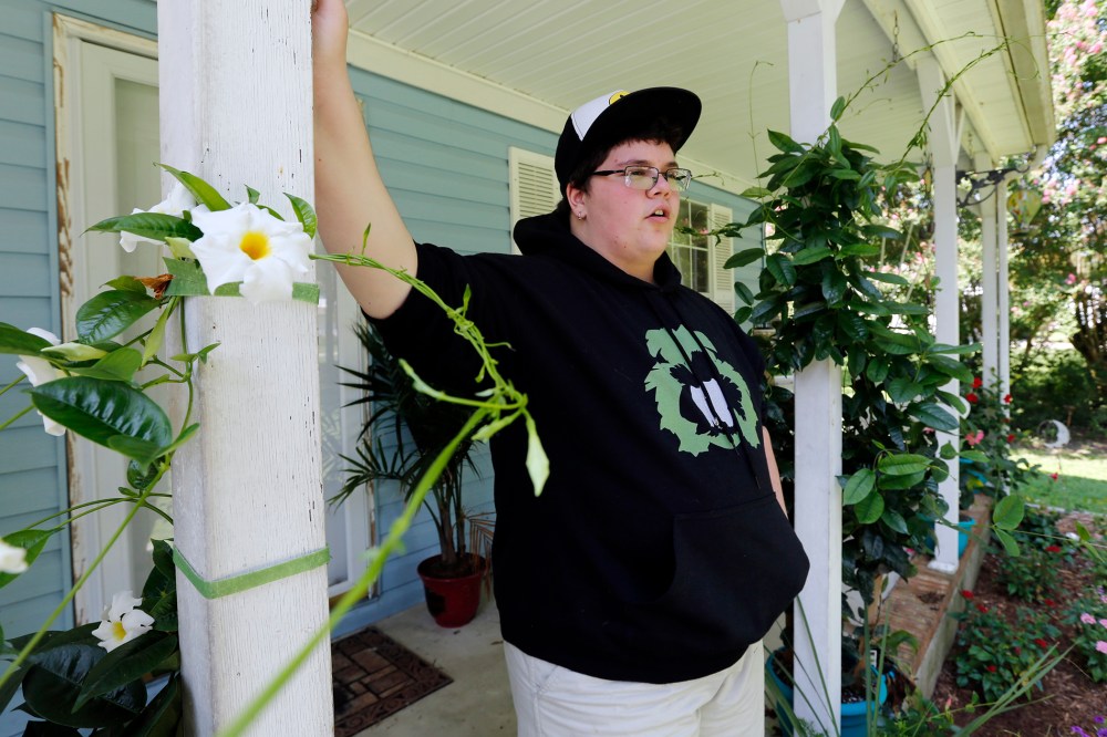 This Aug. 25, 2015 photo shows Gavin Grimm leaning on a post on his front porch during an interview at his home in Gloucester, Va. (Photo by Steve Helber/AP)