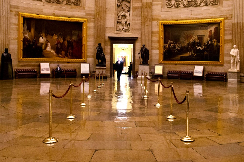 A man walks through a nearly empty Capitol Rotunda on Capitol Hill in Washington. (Photo by Evan Vucci/AP)