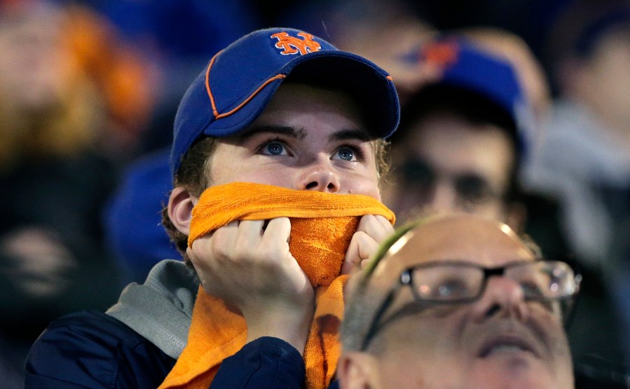 New York Mets fans watch during the 12th inning of Game 5 of the Major League Baseball World Series against the Kansas City Royals, Nov. 2, 2015, in New York. (Photo by Peter Morgan/AP)