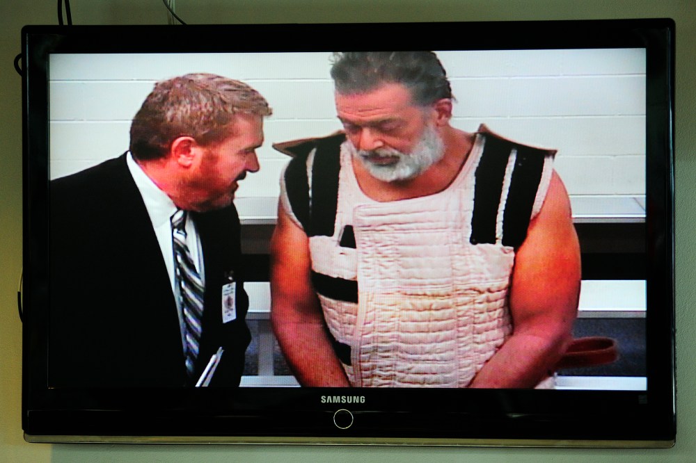 Colorado Springs shooting suspect Robert Dear appears via video before Judge Gilbert Martinez, with public defender Dan King, at the El Paso County Criminal Justice Center, Colo., Nov. 30, 2015. (Photo by Daniel Owen/Pool/AP)