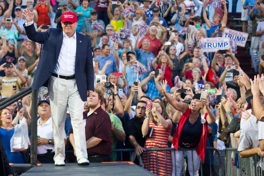 Republican presidential candidate Donald Trump waves to supporters during a campaign rally in Mobile, Ala. on Aug. 21, 2015. (Photo by Brynn Anderson/AP)