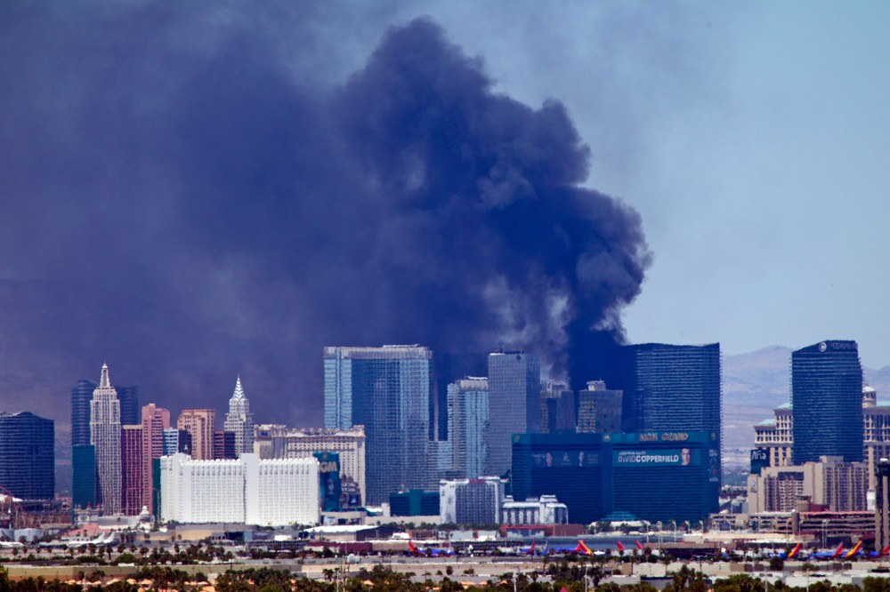 Smokes billows from a fire on the outside pool area of the Cosmopolitan Las Vegas hotel-casino in Las Vegas, Nev. on July 25, 2015. (Photo by Steve Marcus/Las Vegas Sun/AP)