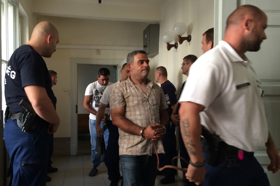 Two men, second right and centre rear, accused of being involved in the trafficking of the 71 migrants found dead in a truck in Austria, at a court in Kecskemet Hungary on Aug. 29, 2015. (Photo by Pablo Gorondi/AP)