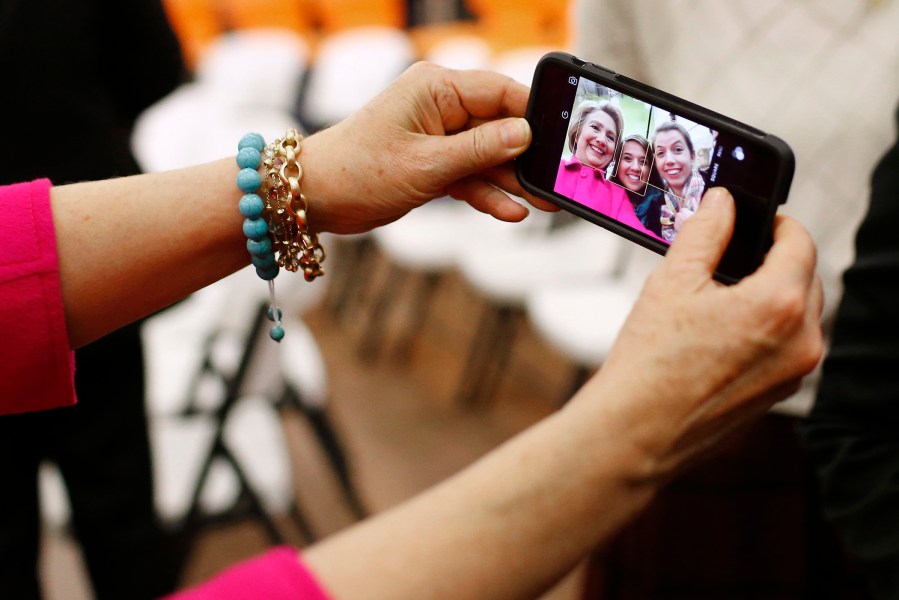 Hillary Clinton shoots a selfie with supporters after a town hall at NewBo City Market in Cedar Rapids, Iowa, Jan. 4, 2016. (Photo by Patrick Semansky/AP)