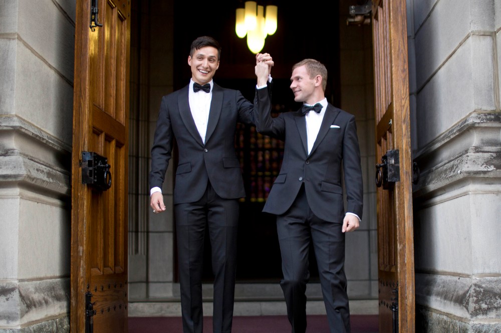 West Point graduate Larry Lennox-Choate, left, and Daniel Lennox-Choate, leave church following their wedding ceremony on Nov. 2, 2013, at the U.S. Military Academy's Cadet Chapel in West Point, N.Y. (Photo by Jill Knight/AP)