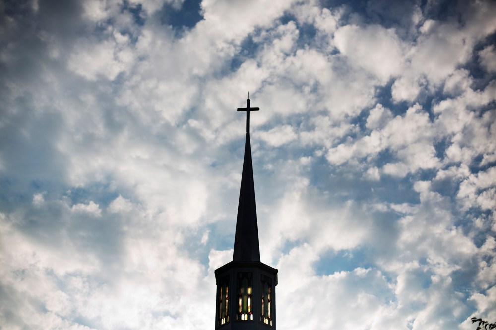 The sun rises behind the steeple of a church, Aug. 23, 2015, in Plains, Ga. (Photo by David Goldman/AP)