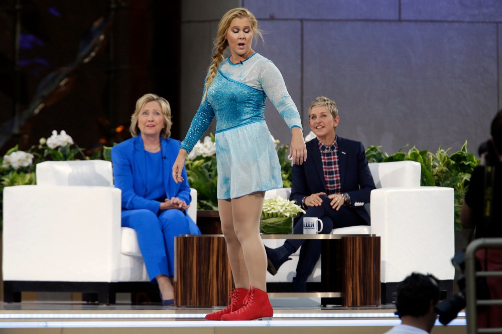Actress Amy Schumer, center, skates past Democratic presidential candidate Hillary Rodham Clinton as she speaks to Ellen DeGeneres during a taping of The Ellen DeGeneres Show, Tuesday, Sept. 8, 2015, at Rockefeller Center, NY. (Photo by Mary Altaffer/AP)