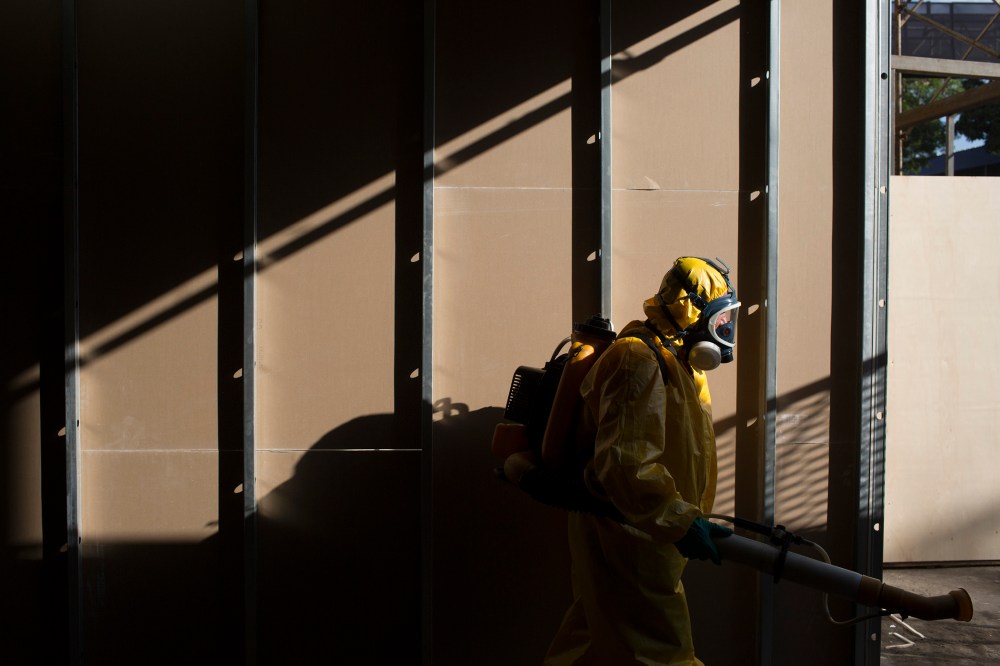 A health worker sprays insecticide to combat the Aedes aegypti mosquitoes that transmits the Zika virus under the bleachers of the Sambadrome in Rio de Janeiro, Brazil, Jan. 26, 2016. (Photo by Leo Correa/AP)