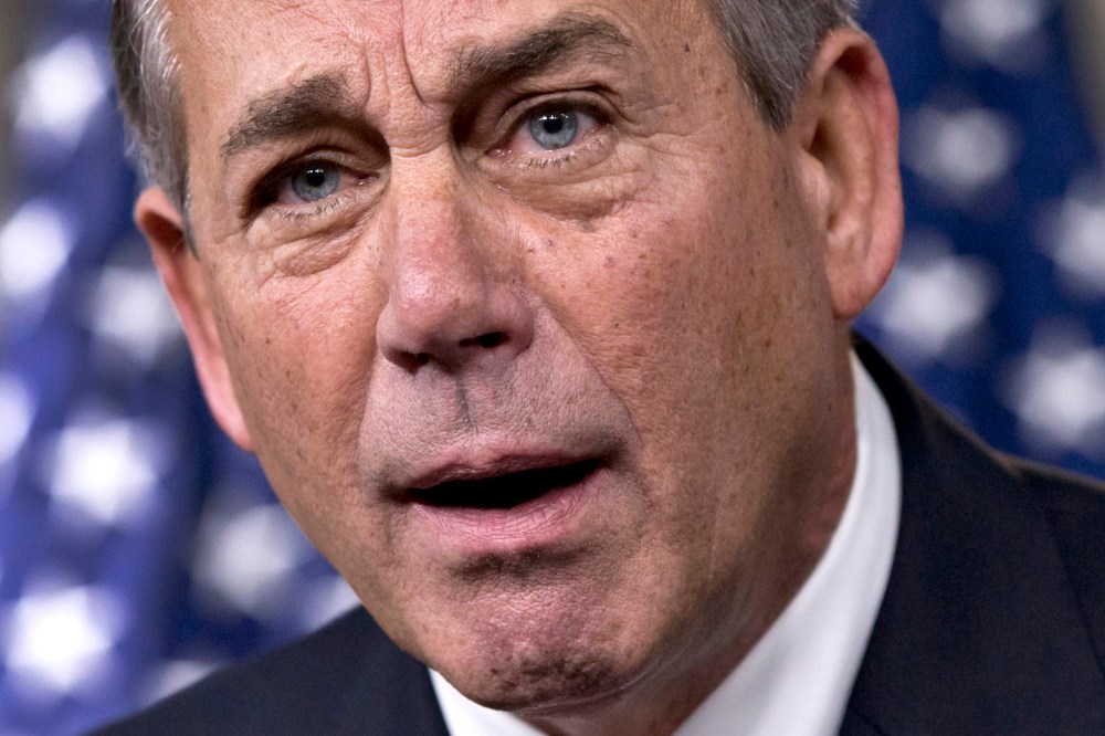 House Speaker John Boehner of Ohio reacts in animated fashion to criticism by conservative groups of a bipartisan budget bill, December 12, 2013, during a news conference on Capitol Hill in Washington.