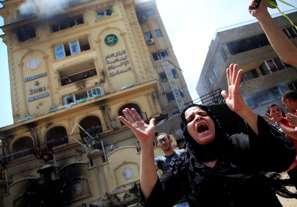 An Egyptian woman chants slogans, as protesters ransack the Muslim Brotherhood headquarters in the Muqattam district in Cairo, Monday, July 1, 2013. Protesters stormed and ransacked the headquarters of President Mohammed Morsi's Muslim Brotherhood...