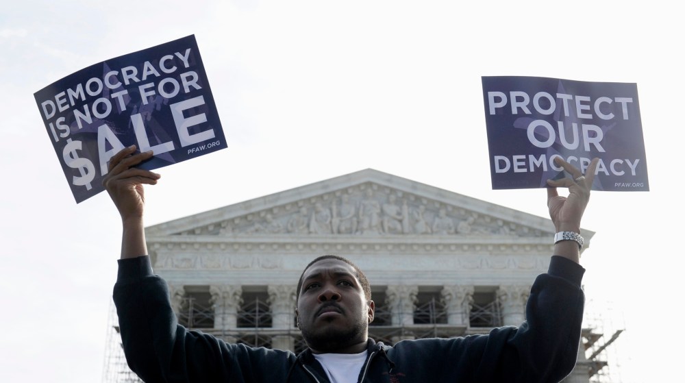 Cornell Woolridge takes part in a demonstration outside the Supreme Court in Washington as the court heard arguments on campaign finance, October 8, 2013.