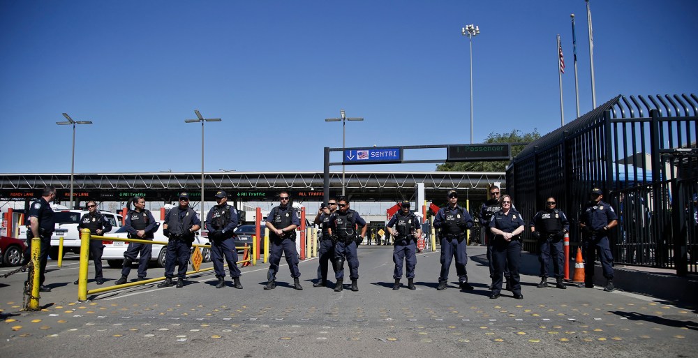 U.S. Customs and Border Protection officers block entry lanes into the United States as the group Border Dreamers and othersmarch toward the U.S. border, March 10, 2014, in Tijuana, Mexico.