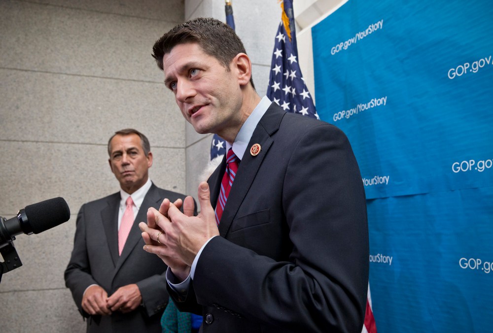 House Budget Committee Chairman Rep. Paul Ryan, R-Wis., right, accompanied by House Speaker John Boehner of Ohio, left, takes reporters' questions as during a news conference on Capitol Hill in Washington, Wednesday, December 11, 2013.