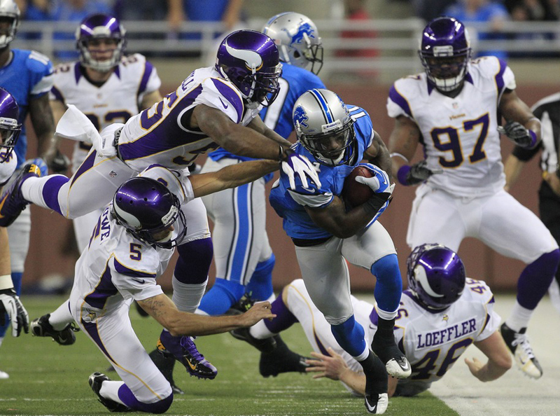 Minnesota Vikings outside linebacker Marvin Mitchell (55) and punter Chris Kluwe (5) take down Detroit Lions' Stefan Logan (11) as he returns a punt during the third quarter of an NFL football game against the Minnesota Vikings at Ford Field in Detroit...