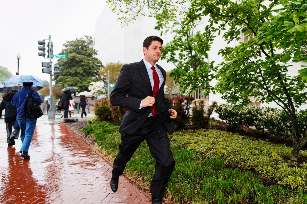 House Budget Committee Chairman Rep. Paul Ryan, R-Wis. dashes through a downpour on the way to a House Republican Conference breakfast, April 29, 2014.