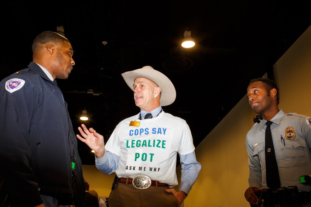 Howard "Cowboy" Wooldridge, co-founder of Law Enforcement Against Prohibition, speaks to two Prince Georges County police officers at CPAC in National Harbor, Md., on Feb. 27, 2015. (Photo by Melissa Golden/Redux for MSNBC)
