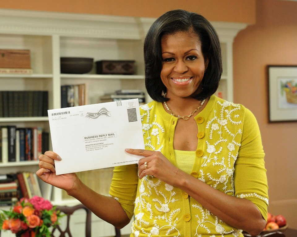 Michelle Obama holding up her absentee ballot