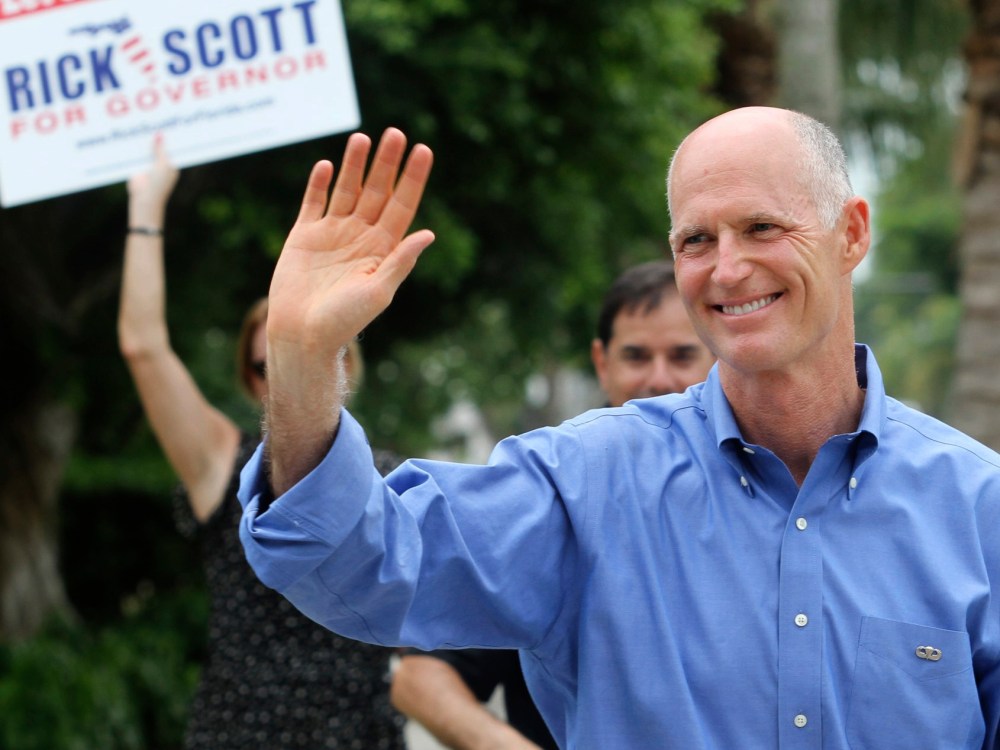 File Photo: Florida Republican Gubernatorial candidate Rick Scott greets supporters near his precinct Tuesday Aug. 24, 2010, in Naples, Fla. (Photo by Erik Kellar/AP Photo/File)