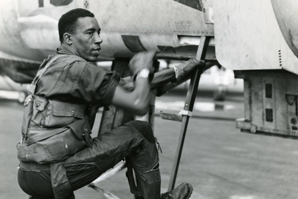 Lieutenant Colonel Frank E. Petersen, Jr. climbs into his phantom jet for a combat mission in Vietnam in 1968. (Photo by SSgt Stacy/Marine Corps)
