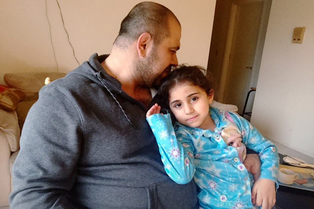 Amjad and his daughter rest in their home in Ohio. (Photo by Amanda Sakuma)