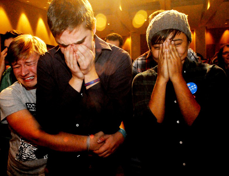 Anthony Streiff, Alex Sand and Nam Dorjee, all of Minneapolis, in tears upon learning voters rejected a proposed amendment to Minnesota's Constitution to ban gay marriage. (Jean Pieri/AP Photo)