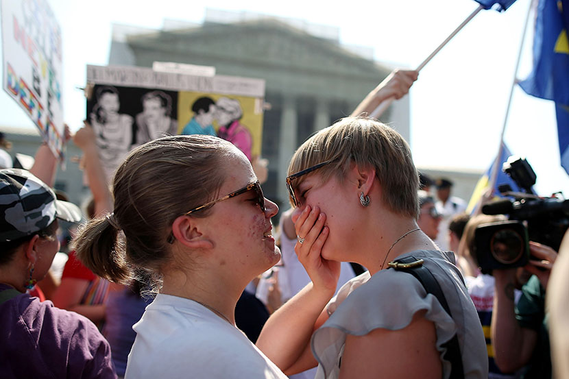 American University students Sharon Burk (L) and Mollie Wagoner (R) embrace after hearing that the U.S. Supreme Court ruled that the Defense of Marriage Act (DOMA) is unconstitutional at the Supreme Court, June 26, 2013 in Washington, DC. (Photo by...