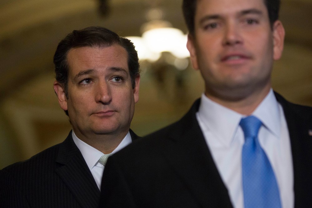 Senator Ted Cruz looks on as Senator Marco Rubio speaks during a news conference with following a vote in Washington, D.C., Sept. 27, 2013. (Photo by Andrew Harrer/Bloomberg/Getty)