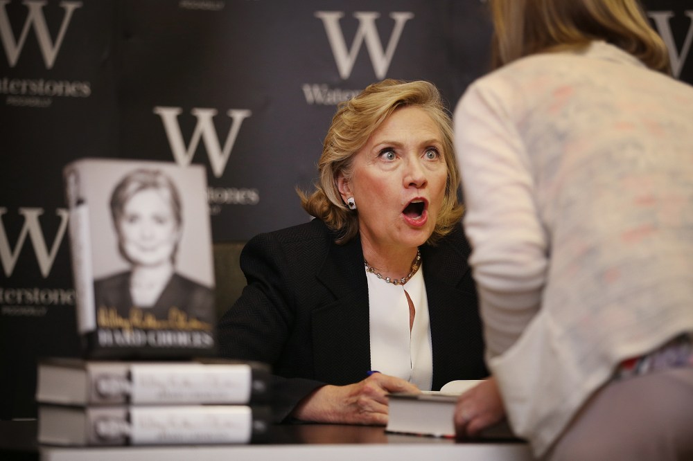 Former US Secretary of State Hillary Clinton reacts to a customer as she signs copies of her book at Waterstones bookshop on July 3, 2014 in London, England. (Photo by Peter Macdiarmid/Getty)