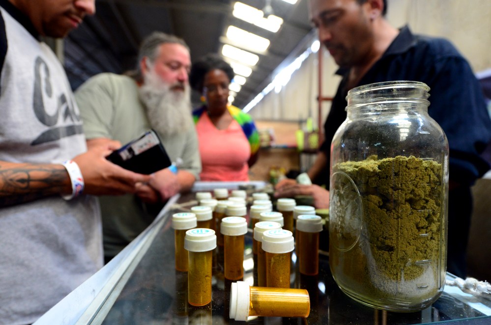 Card-carrying medical marijuana patients learn about Kief, in jar, at Los Angeles' first-ever cannabis farmer's market at the West Coast Collective medical marijuana dispensary, on Independence Day, July 4, 2014. (Photo by Frederic J. Brown/AFP/Getty)