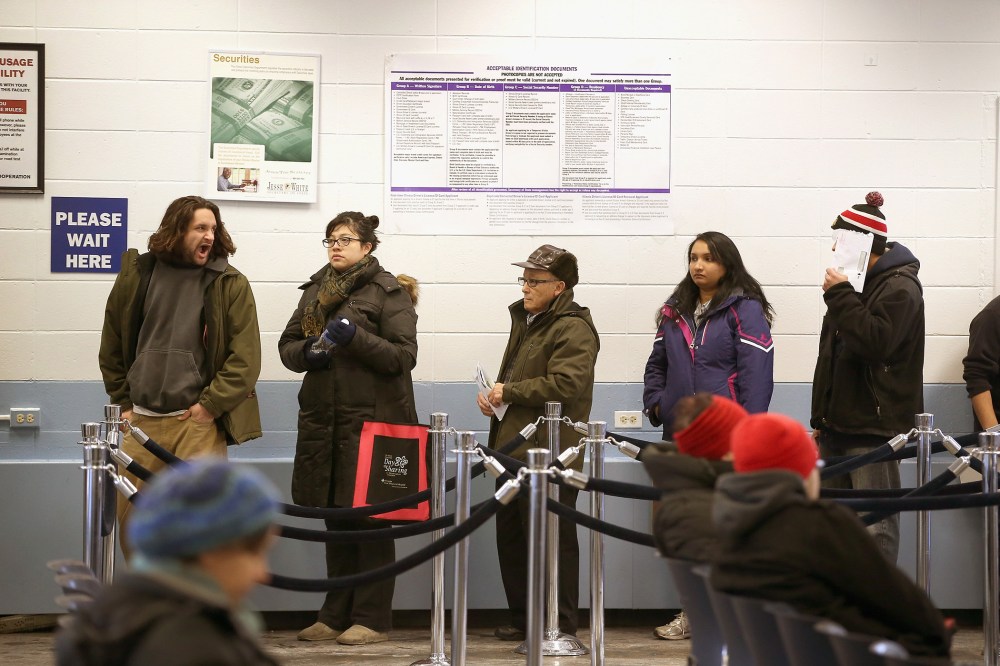 Illinois residents wait in line to apply for or renew their driver's license at a driver services facility on Dec. 10, 2013. (Photo by Scott Olson/Getty)