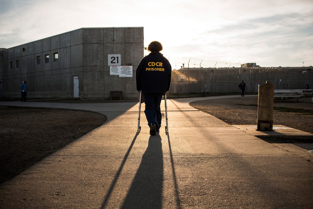 George Whitfield, age 56 and in prison for marijuana-related charges, uses a walker to walk back to his cell block at California State Prison, Solano, on December 16, 2013 in Vacaville, California. (Photo by Andrew Burton/Getty)
