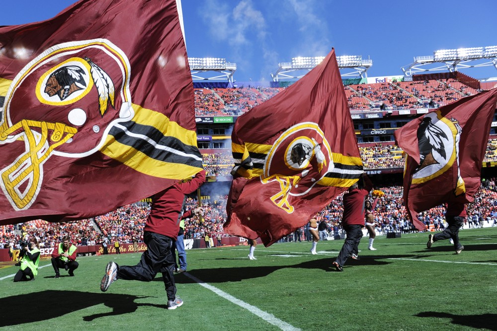 The flag crew runs onto the field before the game between the Washington Redskins and the Tennessee Titans at FedEx Field on Oct. 19, 2014. (Photo by Toni L. Sandys/The Washington Post/Getty)