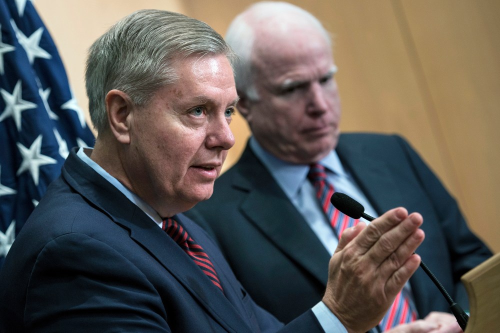 Senator Lindsey Graham speaks near Senator John McCain during a press conference at the David Citadel hotel on Jan. 3, 2014. (Photo by Brendan Smialowski/AFP/Getty)