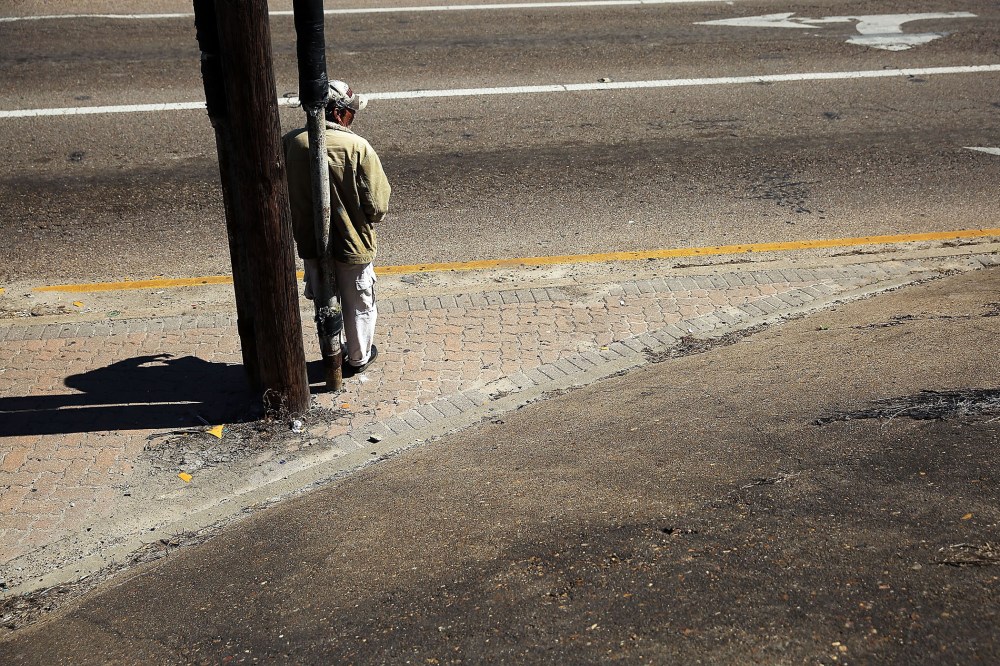 A homeless man looks for donations along a highway entrance on March 28, 2015 in Corpus Christi, Texas. (Photo by Spencer Platt/Getty)