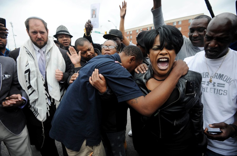 Rev. Pamela Coleman, prays with Baltimore residents on May 1, 2015 after charges were filed against six Baltimore police officers in the death of Freddie Gray in Baltimore, Md. (Kim Hairston/Baltimore Sun/TNS/Getty)