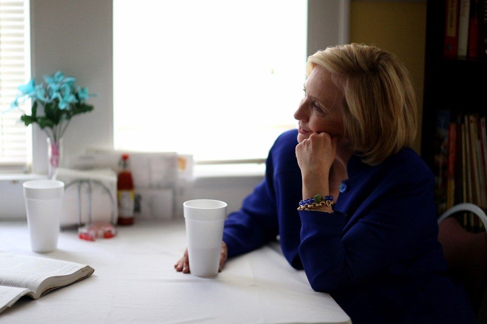 Democratic Presidential candidate Hillary Clinton sits with a customer as she visits the Main Street Bakery in Columbia, S.C. on May 27, 2015 (Photo by Joe Raedle/Getty).