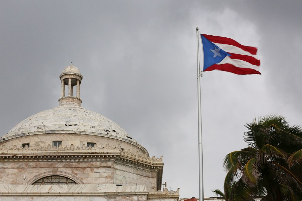 The Puerto Rican flag flies near the Capitol building as the island's residents deal with the government's $72 billion debt on July 1, 2015 in San Juan, Puerto Rico. (Photo by Joe Raedle/Getty)