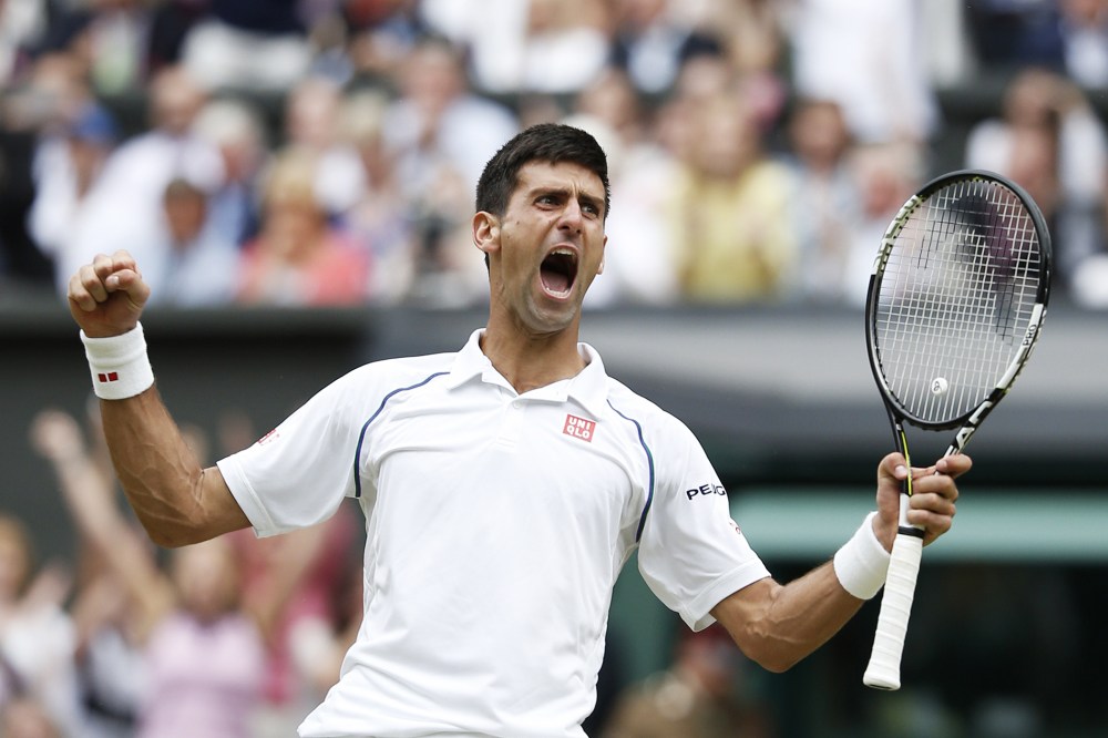 Serbia's Novak Djokovic celebrates beating Switzerland's Roger Federer during their men's singles final match on Centre Court at the 2015 Wimbledon Championships in Wimbledon, southwest London, on July 12, 2015.(Photo by Adrian Dennis/AFP/Getty)