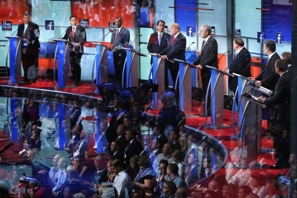 Audience members are reflected in a window as Republican presidential candidates participate in the presidential debate hosted by FOX News and Facebook at the Quicken Loans Arena on Aug. 6, 2015 in Cleveland, Ohio. (Photo by Chip Somodevilla/Getty)