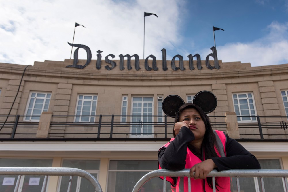 A steward is seen outside Bansky's 'Dismaland' exhibition at a derelict seafront lido on Aug. 20, 2015 in Weston-Super-Mare, England. (Photo by Matthew Horwood/Getty)