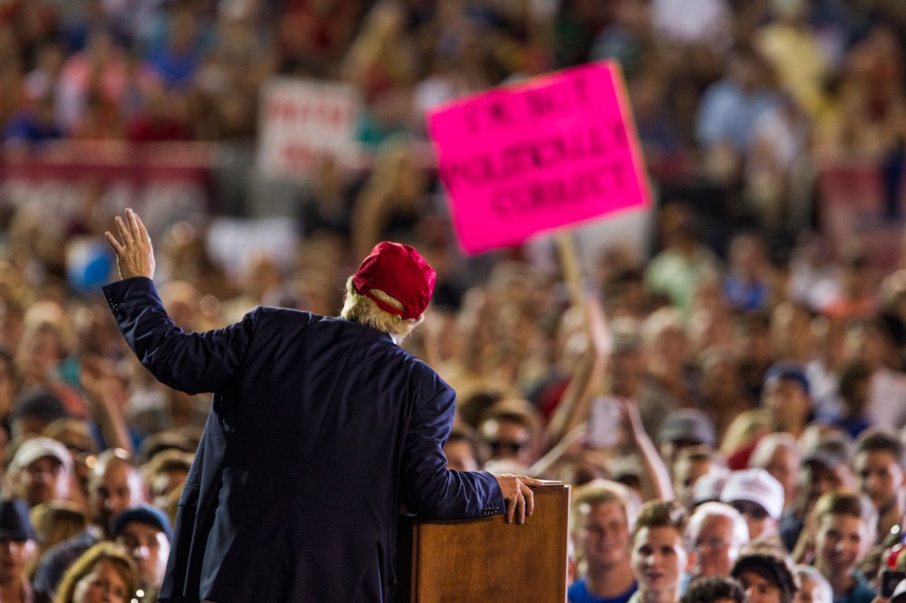 A Donald Trump supporter's sign reads "I'm Not Politically Correct" as the Republican presidential candidate speaks during a rally on August 21, 2015 in Mobile, Alabama. (Photo by Mark Wallheiser/Getty)