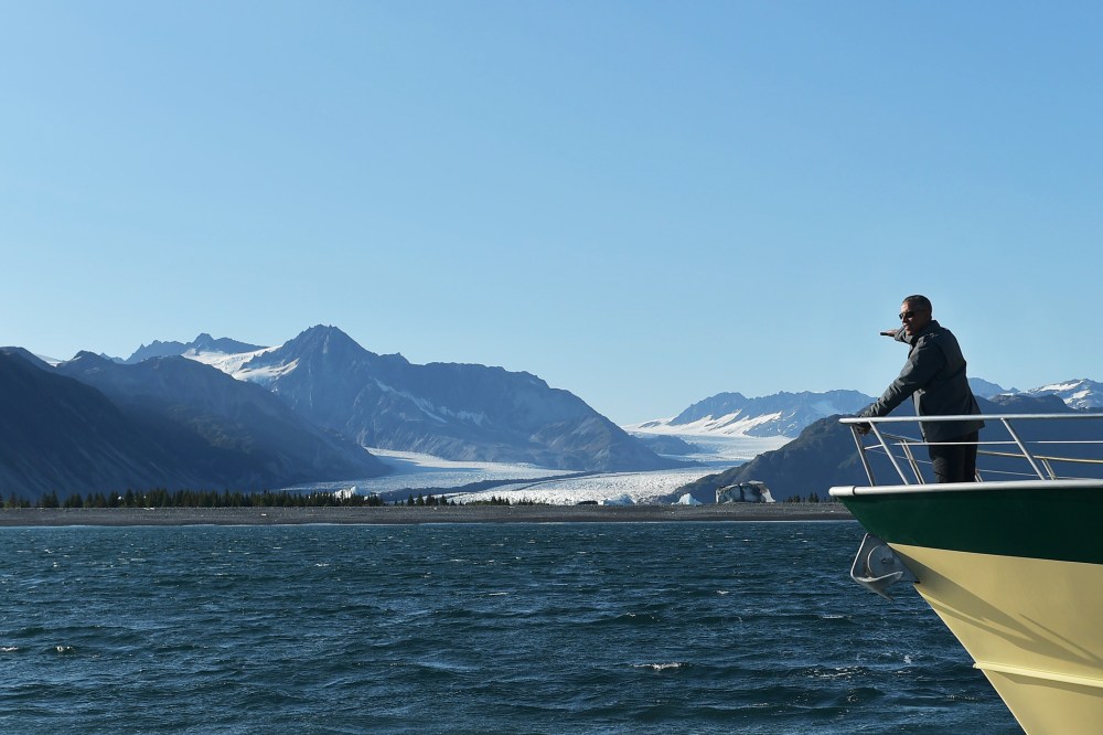 President Barack Obama points to Bear Glacier during a boat tour of the Kenai Fjords National Park on Sept. 1, 2015 in Seward, Alaska. (Photo by Mandel Ngan/AFP/Getty)