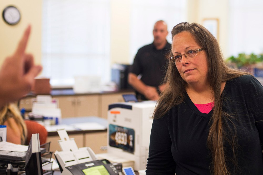 Kim Davis, the Rowan County Clerk of Courts, listens to Robbie Blankenship and Jesse Cruz as they speak with her about getting a marriage license at the County Clerks Office on Sep. 2, 2015 in Morehead, Ky. (Photo by Ty Wright/Getty)