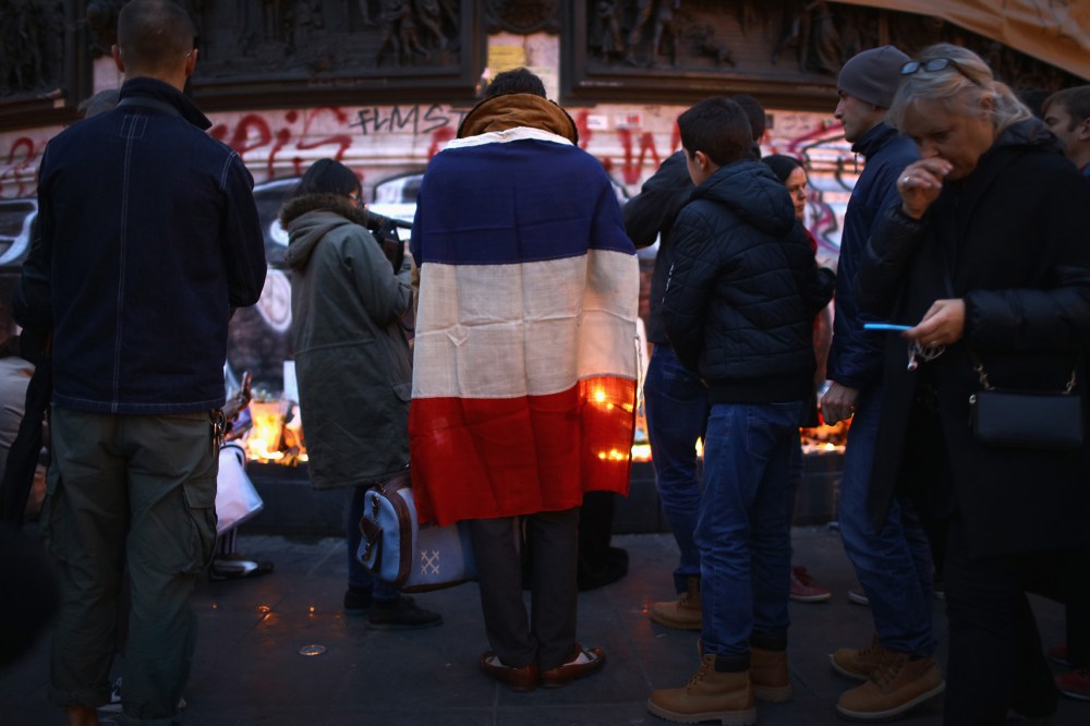 Parisians light candles and lay tributes on the monument at Place de la Republique, the day after deadly terrorist attacks on Nov. 14, 2015 in Paris, France. (Photo by Christopher Furlong/Getty)