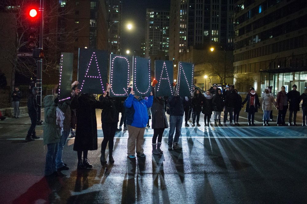 Demonstrators march through downtown following the release of a video showing Chicago Police officer Jason Van Dyke shooting and killing Laquan McDonald on Nov. 24, 2015 in Chicago, Ill. (Photo by Scott Olson/Getty)