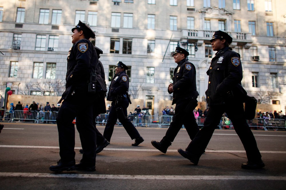Members of the New York City Police department walk on Central Park West before the annual Thanksgiving Day Parade on Nov. 26, 2015 in New York City. (Photo by Kena Betancur/Getty)